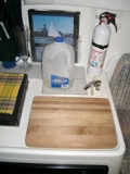 water jug 
sink covered 
by cutting board